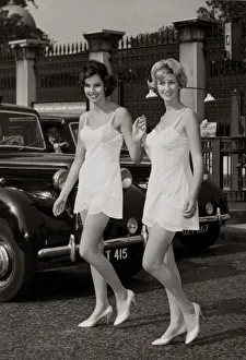 Two models walking by Hyde park corner wearing their slips after slipping out from a Two models walking by Hyde park corner wearing their slips after slipping out from a