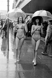 Images Dated 14th April 1975: Models Wendy and Jackie seen here modeling the latest in swimwear on a wet Oxford Street