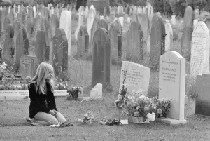 Mourner Margaret Lowe kneels at the grave stone of former Rolling Stones guitarist Brian Mourner Margaret Lowe kneels at the grave stone of former Rolling Stones guitarist Brian