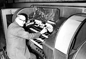 Mr. Wilf Donnelly of the Theatre Organ Club seated at the organ of the Odeon
