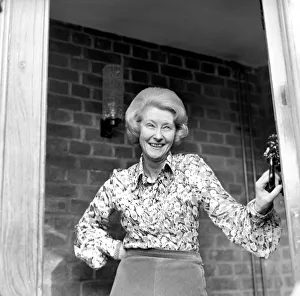 00060 Gallery: Mrs. Babette Barber looking out of her window. April 1975 75-2155