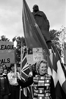 Mrs Margart Thatcher March 1975 holding the European flag under the statue of Sir Winston