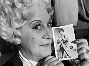 Images Dated 5th July 1977: Mrs Slocombe (Actress Molly Sugden) seen here showing off her passport photograph for a