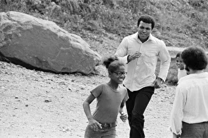 Muhammad Ali chasing a little girl at his training camp in Pennsylvania Muhammad Ali chasing a little girl at his training camp in Pennsylvania