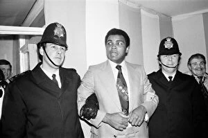 The Peoples Champion Gallery: Muhammad Ali under friendly arrest of two London Police officers who were at the training