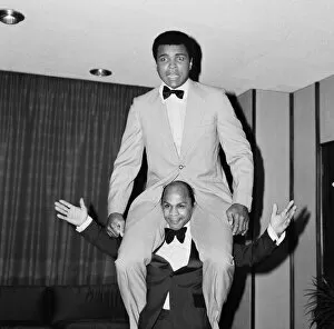 Images Dated 1st January 1974: Muhammad Ali getting a piggy back from another guest at a press conference