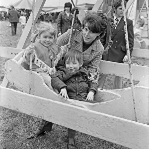 Mum with son and daughter enjoying the swings at Silcocks Fair at Skelmersdale 17th May