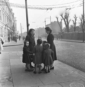 Mums and children gather on a corner of the Harrow Road close to the Regent Canal Mums and children gather on a corner of the Harrow Road close to the Regent Canal