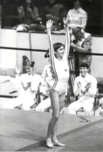 Nadia Comaneci of Romania salutes after a prefect gymnastic score of 10 Nadia Comaneci of Romania salutes after a prefect gymnastic score of 10