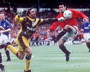 Neville Southall Football goalkeeper for Everton FC bending down to pick up the football Neville Southall Football goalkeeper for Everton FC bending down to pick up the football