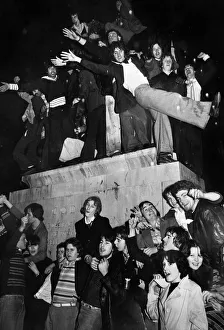 New Year revellers besiege the statue of Lady Godiva during the celebrations to see in New Year revellers besiege the statue of Lady Godiva during the celebrations to see in