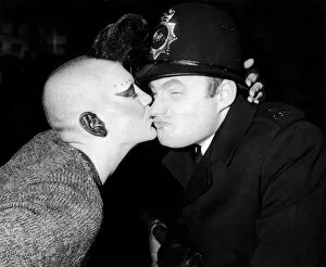 New Years Reveller 1984. So Friendly: A policeman is kissed by a girl punk in Trafalgar