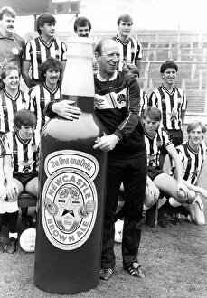 Newcastle United manager Jack Charlton clowning around with a giant Newcastle Brown Ale