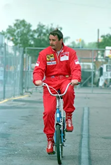 NIGEL MANSELL ON A BIKE AT THE FORMULA 1 BRITISH GRAND PRIX AT SILVERSTONE - July 1989 NIGEL MANSELL ON A BIKE AT THE FORMULA 1 BRITISH GRAND PRIX AT SILVERSTONE - July 1989