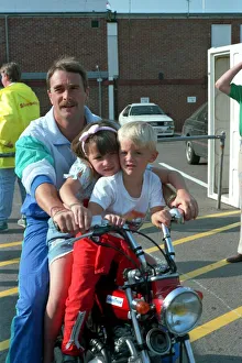 Images Dated 15th July 1989: NIGEL MANSELL AND CHILDREN CHLOE MANSELL AND GREG MANSELL ON A BIKE AT THE FORMULA 1