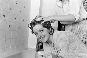 Images Dated 23rd June 1978: The Nolan sisters at home in Ilford. Bernadette helps Linda to wash her hair