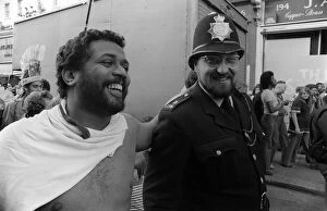 Notting Hill Carnival August 1977 A man laughs and jokes with a police man during