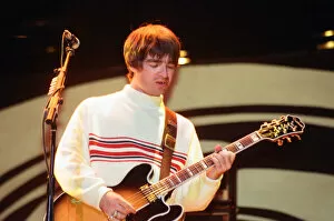 Images Dated 11th August 1996: Oasis in concert at Knebworth, Hertfordshire. Noel Gallagher. 11th August 1996