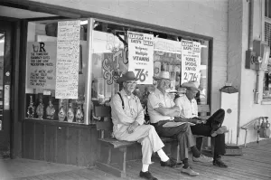Three old timers sit outside the Tombstone Drug store close to the site of the famous Three old timers sit outside the Tombstone Drug store close to the site of the famous