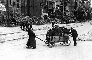 An old woman and her husband trundle through the Leipzig Strasse of Berlin An old woman and her husband trundle through the Leipzig Strasse of Berlin