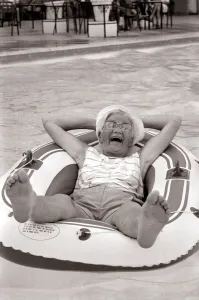 Old woman in an inflatable dinghy in a swimming pool August 1984 Old woman in an inflatable dinghy in a swimming pool August 1984
