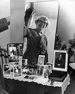 01228 Gallery: Old woman smiling at bedroom mirror in her newly-built Home. 9th october 1963