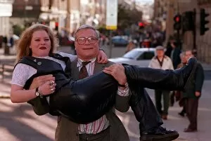 Images Dated 1st February 1996: Oliver Reed actor star of film The Bruce lifting young blonde woman Karen Bruce in his