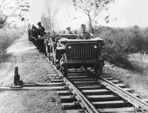 00154 Gallery: A pair of Willys Jeeps adapted for running on railway tracks head southwards