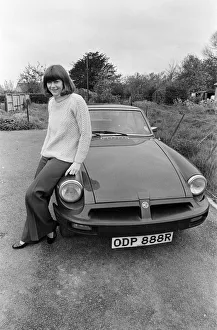 Pam Ayres poses beside her MGB sports car. 12th May 1977 Pam Ayres poses beside her MGB sports car. 12th May 1977