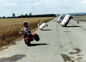Images Dated 20th September 1990: Paul Swift 11 year old daredevil performs wheelies on bikes and cars