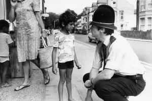 Images Dated 12th August 1981: PC Nigel Barber speaks with a young boy, during patrol pod the streets of Cambridge