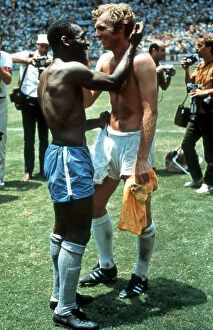 Famous People Gallery: Pele of Brazil and Bobby Moore of England exchange shirts after the World Cup Group C