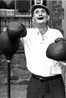 People - Old Man, Jackie McGuire, without any teeth wearing boxing gloves standing by a