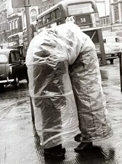 Two people sheltering from the rain - March 1970