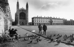 People talking a walk on the lawn outside Kings College in central Cambridge People talking a walk on the lawn outside Kings College in central Cambridge