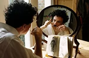 Images Dated 21st January 1992: Peter Duncan actor getting ready for his part as Charlie Chaplin looking in mirror
