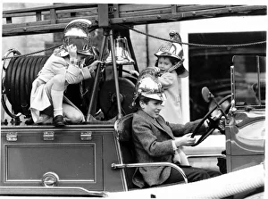 Images Dated 4th January 1988: Peter Phillips takes over the driving of the vintage 1939 fire engine with Prince William