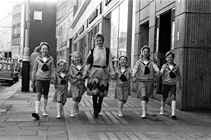 Petula Clark with one of the groups of six children in costume who will be in '