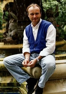 Images Dated 2nd June 1993: Phil Collins singer poses for a picture while sitting on the edge of a water fountain