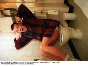 Phil MacKay Grampian TV Presenter with his hands over his ears sitting on toilet wc Phil MacKay Grampian TV Presenter with his hands over his ears sitting on toilet wc
