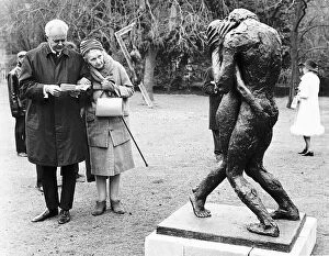 A photograph of an elderly couple viewing the sculpture 'Eternity I I"