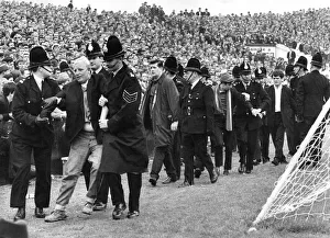Supporters And Spectators Gallery: Police escort fans from the terraces at the Manchester City v