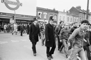 Police keep an eye on Leeds United supporters at the Arsenal football ground as fans Police keep an eye on Leeds United supporters at the Arsenal football ground as fans