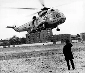 Images Dated 8th November 1980: A policeman looks on as a RAF search and rescue Sea King helicopter from RAF Boulmer