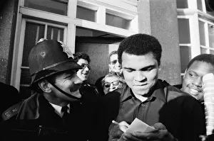 A policeman smiles at Muhammad Ali as he signs autographs in London A policeman smiles at Muhammad Ali as he signs autographs in London