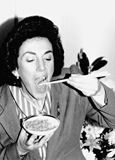 Politician Edwina Currie eating rice with chopsticks April 1988