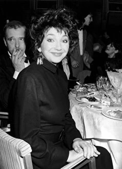 Images Dated 10th February 1987: Pop singer Kate Bush sitting at a dinner table February 1987