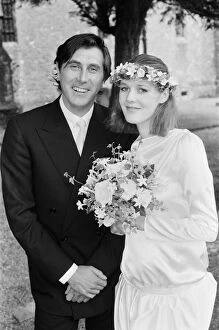 Pop star Bryan Ferry poses with his bride Lucy Helmore after thier wedding ceremony at St
