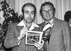 Images Dated 26th October 1976: Pop star Elton John also chairman of Watford football club seen here with Bobby Moore at