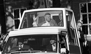 Pope John Paul II during his visit to Britain in 1982 rides along in his Popemobile